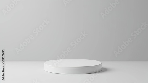 A minimalist white circular platform in a simple gray setting, ideal for showcasing products with elegance and focus.