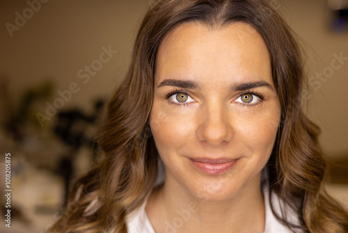 portrait of a beautiful girl in a white blouse with dark hair smiling