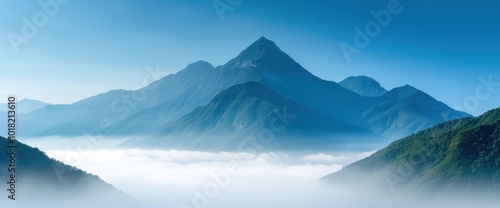 Breathtaking Mountain Landscape Surrounded by Misty Clouds in a Serene Blue Sky photo