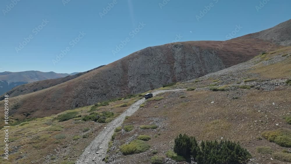 Panoramic orbit behind truck driving up along dirt road in grassy forest on Peak 10 trail Breckenridge Colorado Panoramic orbit behind truck driving up along dirt road in grassy forest on Peak 10 trail Breckenridge Colorado