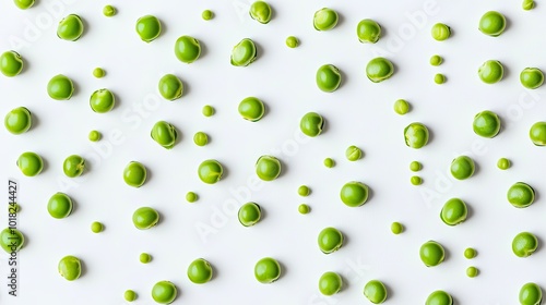 Bright green pea seeds scattered on a white background, some still inside their open pods.