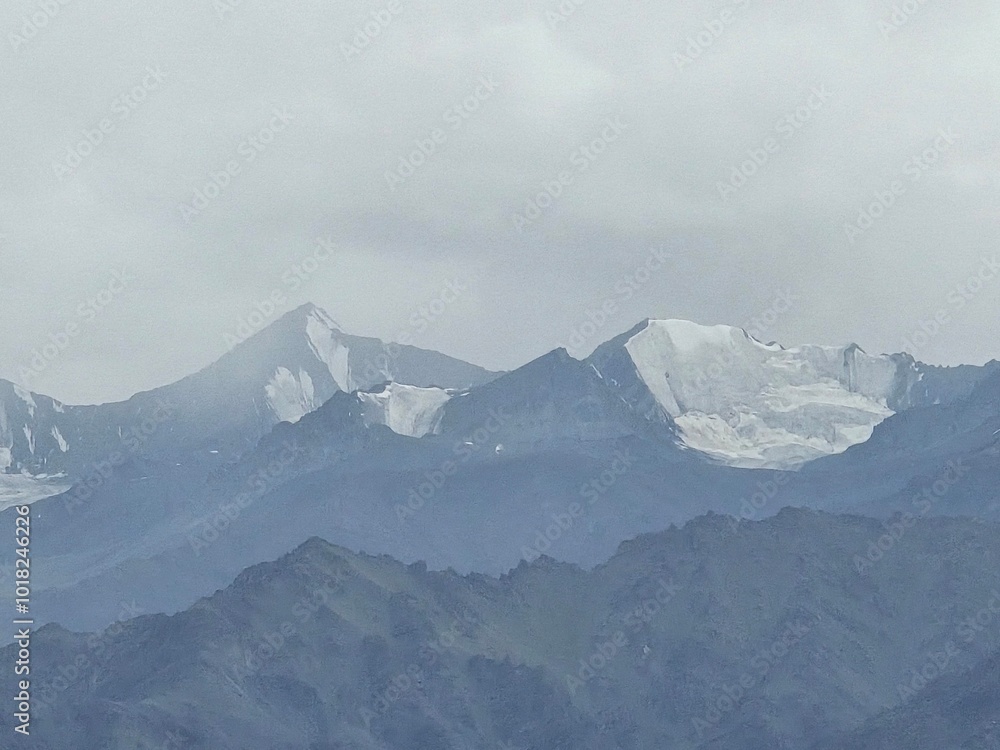 Misty Mountain Majesty: An ethereal landscape of snow-capped peaks shrouded in a veil of mist, evoking a sense of tranquility and awe. Misty Mountain Majesty: An ethereal landscape of snow-capped peaks shrouded in a veil of mist, evoking a sense of tranquility and awe.