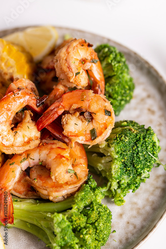 Shrimp and vegetables cooked in the oven for a healthy lunch on a white table