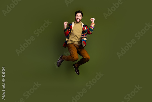 Photo of positive overjoyed man wear stylish clothes celebrate achievement isolated on khaki color background