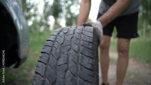 The young mechanic changes the wheels