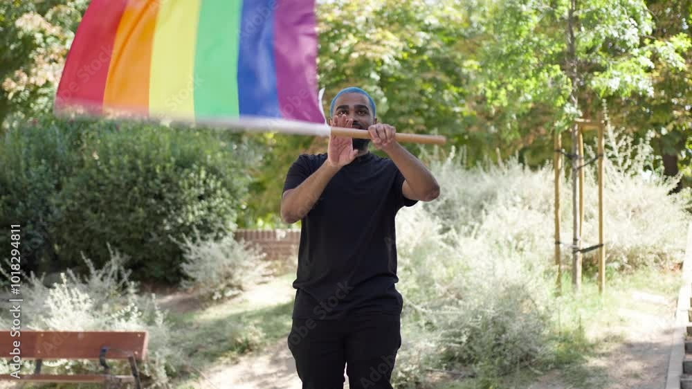 Bearded gay black man blue haired waving LGBTQ rainbow flag. Gay pride, equal rights, gender equality.MOV Bearded gay black man blue haired waving LGBTQ rainbow flag. Gay pride, equal rights, gender equality.MOV