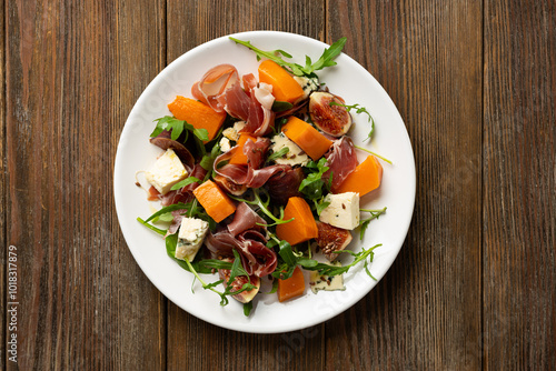 Overhead view of jamon blue cheese and figs  pumpkin salad rocket on white plate