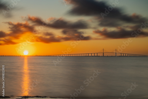 A morning sunrise at the Sunshine Skyway Bridge over Tampa Bay, St Petersburg, Florida September 2024. A beautiful sunrise at the beach in Fort DeSoto Park looking at The Sunshine Skyway Bridge over T