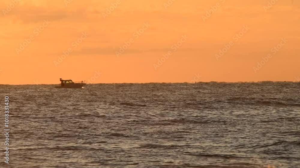 A ship sailing at dawn. Beautiful sunrise over the sea. The morning sun illuminates the sea. Dawn in the Mediterranean Sea. Sun reflections in the water, boat A ship sailing at dawn. Beautiful sunrise over the sea. The morning sun illuminates the sea. Dawn in the Mediterranean Sea. Sun reflections in the water, boat