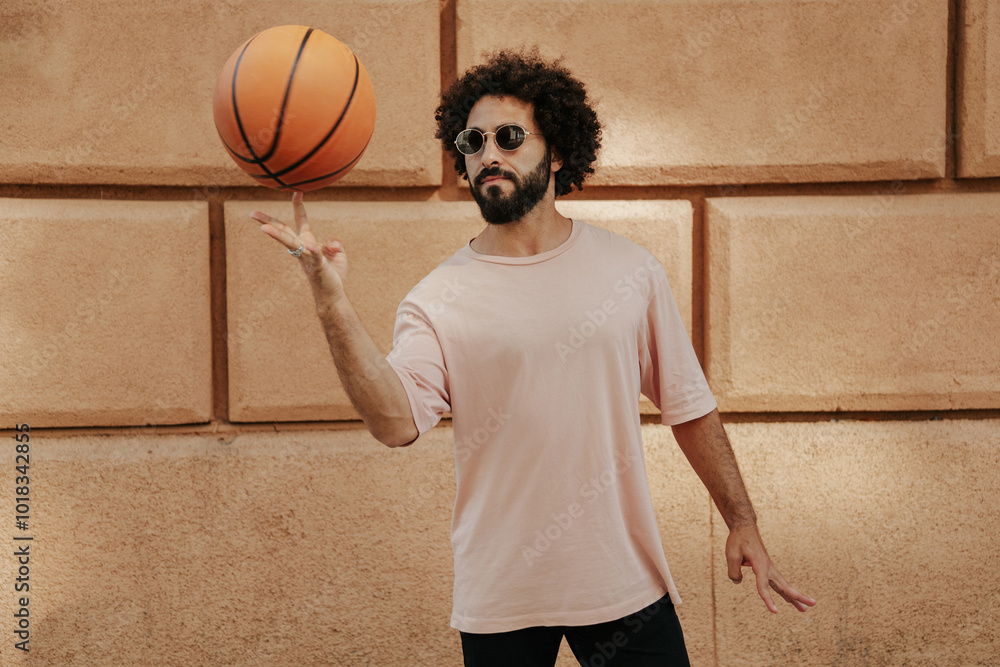 Young Arabian with a beard and afro hairstyle with basketball ball