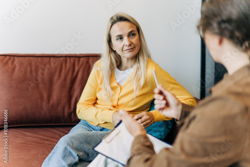 A woman is consulting with a psychologist in the office. photo