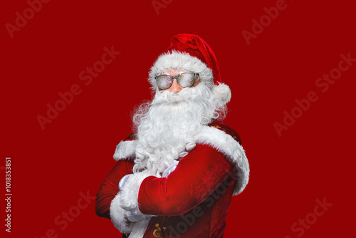 Cool Santa Claus is in sunglasses with arms crossed.