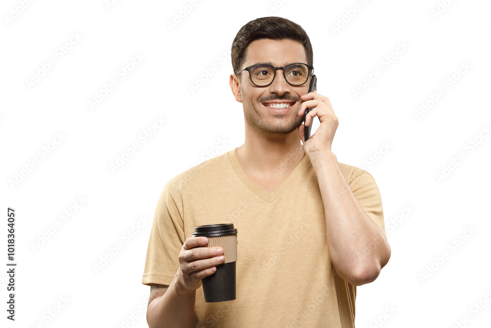 Young handsome businessman in beige t-shirt and glasses, talking on phone with takeaway coffee cup in hands Young handsome businessman in beige t-shirt and glasses, talking on phone with takeaway coffee cup in hands