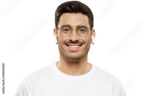 Close-up portrait of young handsome smiling man wearing white t-shirt and wireless earphones, enjoying favorite music photo