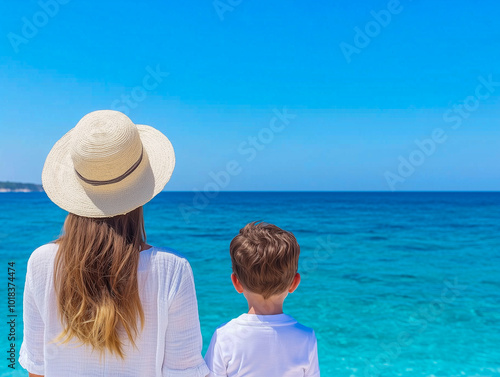 young mother and son stand on the seashore. A woman with a child stands on the beach, rest and travel with children, vacation on the sea. family on vacation at sea 