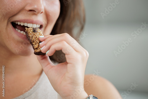 Young woman drinking protein shake and cereal bar, healthy food and drink for after training. Online trainer.