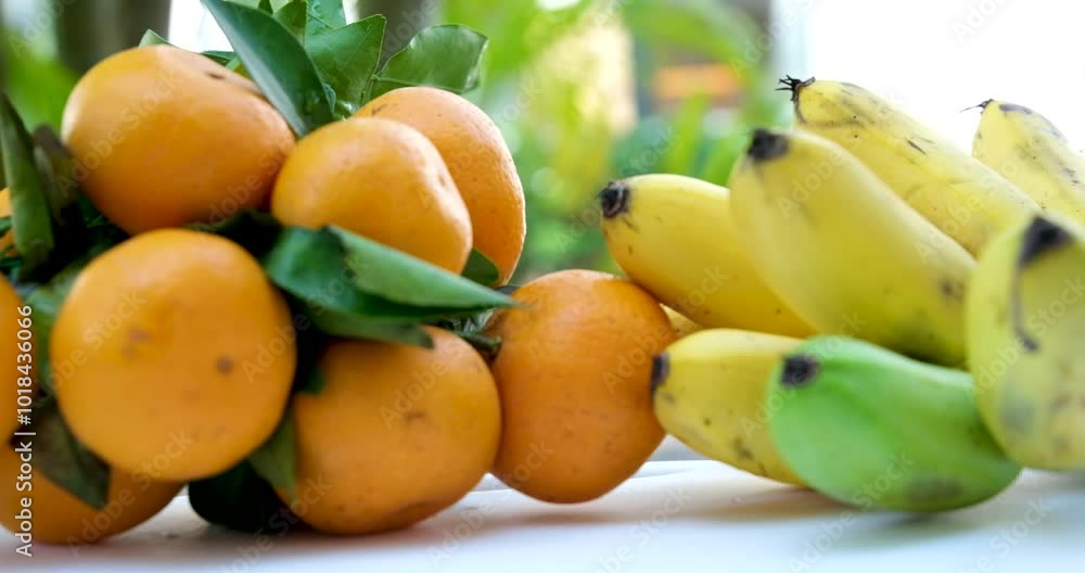 bananas and tangerines. Beautiful dynamic view of healthy fruits food bananas and tangerines. Beautiful dynamic view of healthy fruits food