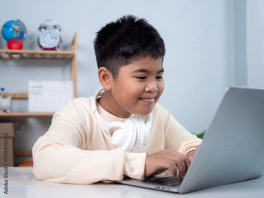 Educational of tech concept, Staying at home, Little Asian boy student using computer laptop learning. Presenting a modern educational way of life. Virtual internet online class from school teacher. Educational of tech concept, Staying at home, Little Asian boy student using computer laptop learning. Presenting a modern educational way of life. Virtual internet online class from school teacher.