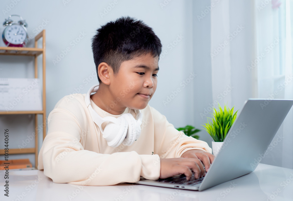 Educational of tech concept, Staying at home, Little Asian boy student using computer laptop learning. Presenting a modern educational way of life. Virtual internet online class from school teacher. Educational of tech concept, Staying at home, Little Asian boy student using computer laptop learning. Presenting a modern educational way of life. Virtual internet online class from school teacher.