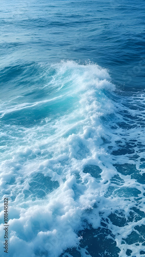 A close-up of a wave cresting and breaking, revealing white foam and blue water beneath, capturing the dynamic beauty of the sea.