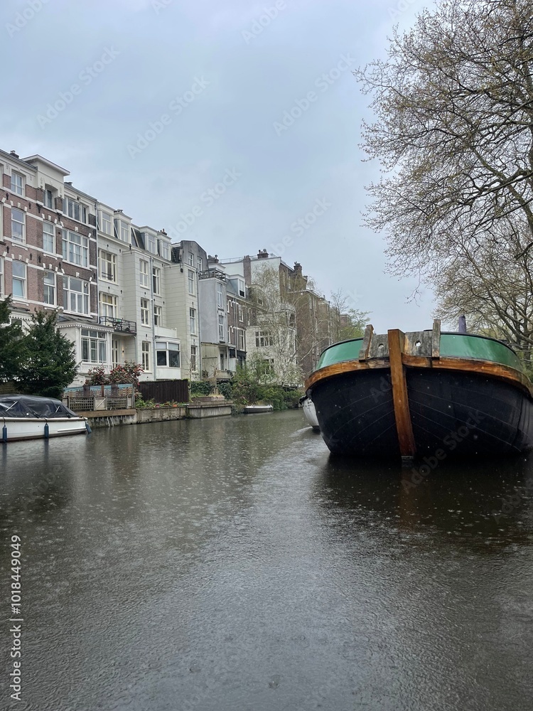 Naklejka premium Traditional boats and canals in Amsterdam, Netherlands, Europe