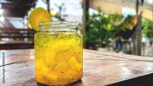 Fresh drink garnished with lemon on the cafe table