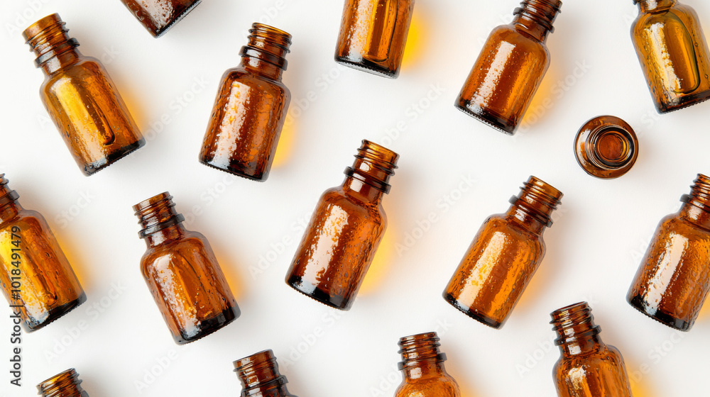A collection of amber glass bottles, perfect for cosmetics, natural remedies, essential oils, or other liquids. They are shown against a white background, viewed from above. A collection of amber glass bottles, perfect for cosmetics, natural remedies, essential oils, or other liquids. They are shown against a white background, viewed from above.