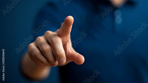 Click to Connect: A close-up shot of a hand reaching out, finger pointing towards the viewer, suggesting interaction, choice, and digital connection.  The image is set against a deep blue background. photo