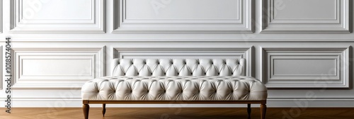 A classic white tufted ottoman sits against a backdrop of elegant white wainscoting, showcasing timeless design and sophistication. This image evokes a sense of luxury, comfort, and refined style. photo