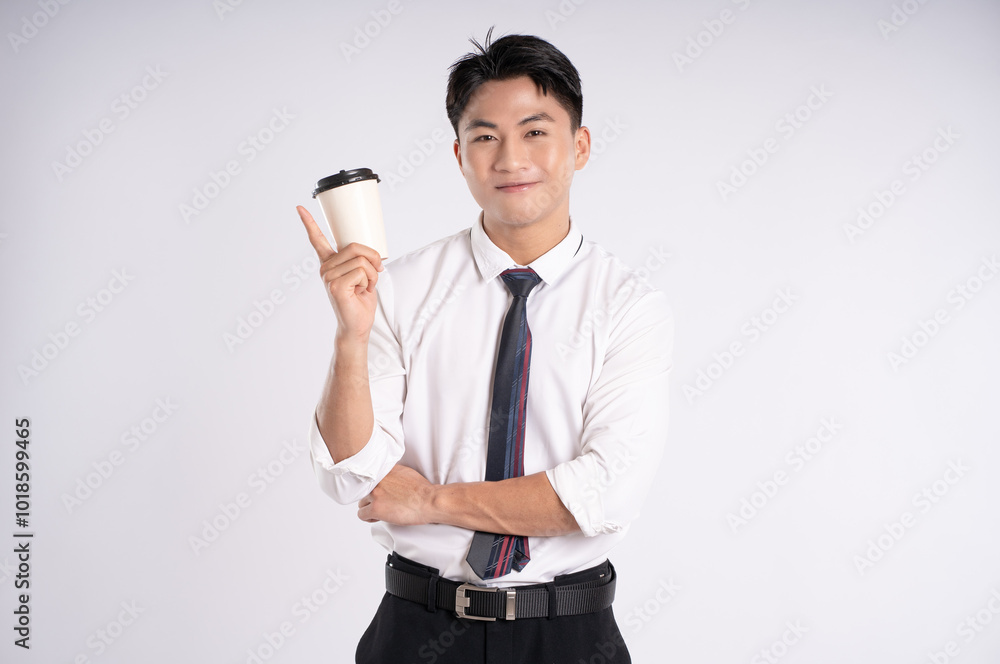 Portrait of young Asian business man drinking coffee and posing on white background Portrait of young Asian business man drinking coffee and posing on white background