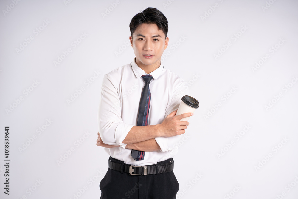 Portrait of young Asian business man drinking coffee and posing on white background Portrait of young Asian business man drinking coffee and posing on white background