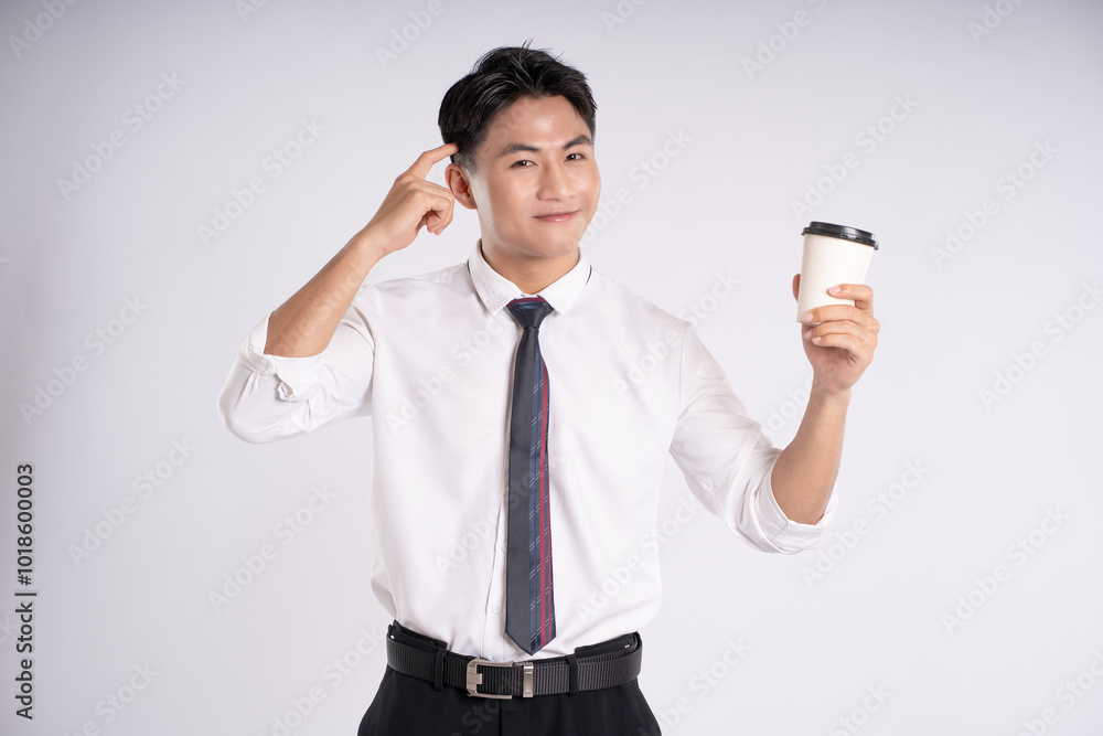 Portrait of young Asian business man drinking coffee and posing on white background Portrait of young Asian business man drinking coffee and posing on white background