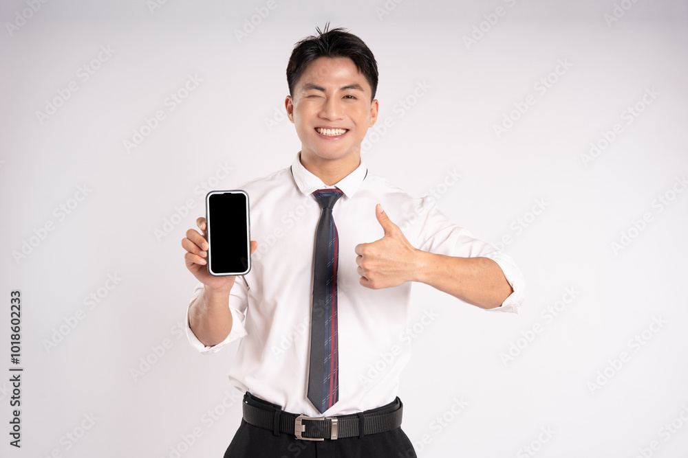 Portrait of young Asian businessman posing and using phone on white background
Portrait of young Asian businessman posing and using phone on white background