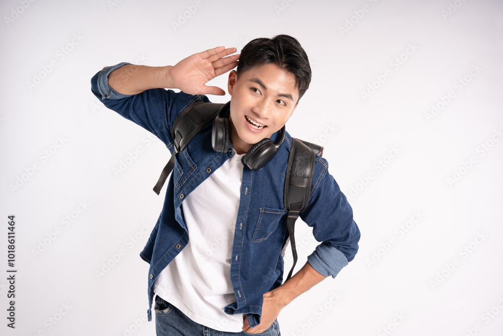 Portrait of Asian male student wearing headphones and schoolbag posing on white background Portrait of Asian male student wearing headphones and schoolbag posing on white background