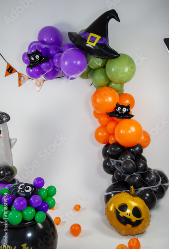 Halloween decorations made of balloons, pumpkin, cauldron and witch's broom