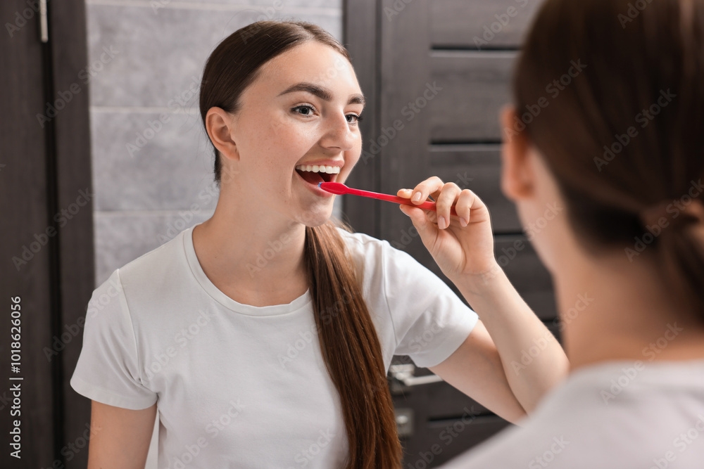Beautiful woman brushing her teeth in bathroom Beautiful woman brushing her teeth in bathroom