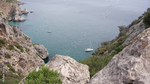 The rugged cliffside contrasts beautifully with the smooth surface of the water. 