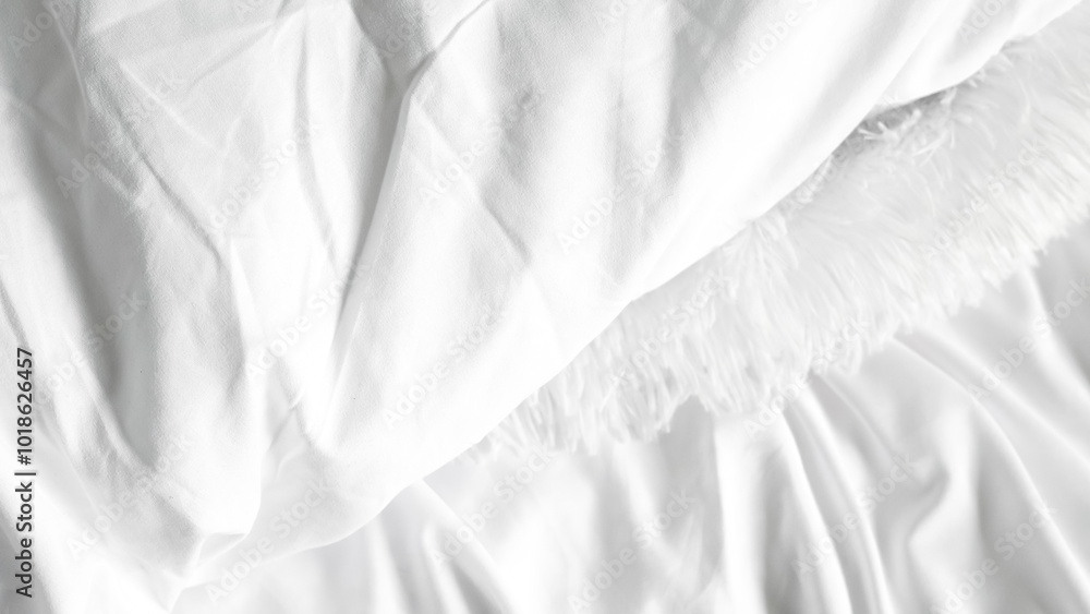 Obraz premium White bedsheets and soft blanket on plain background, minimalistic bedroom style