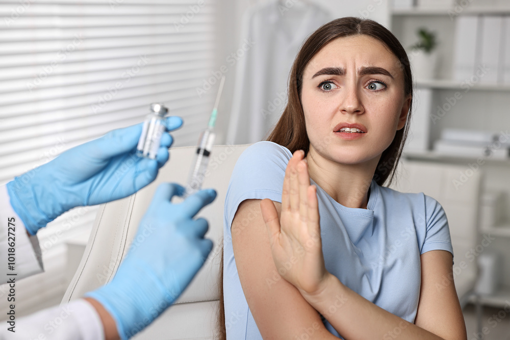 Dental phobia. Dentist with syringe and vial near scared woman in clinic, closeup Dental phobia. Dentist with syringe and vial near scared woman in clinic, closeup