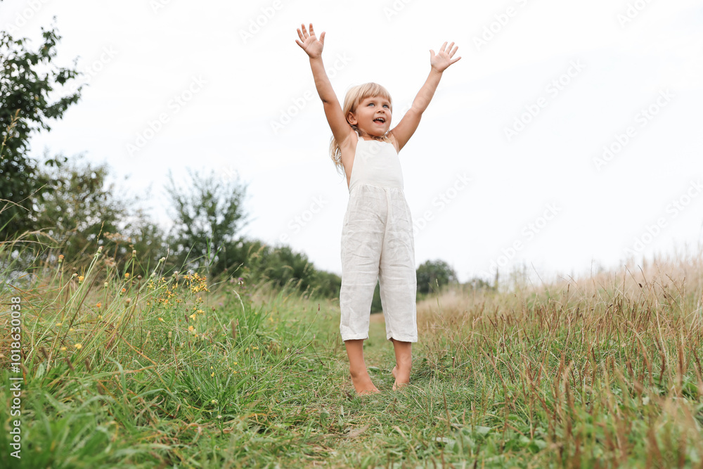 Cute little girl walking barefoot at meadow. Child enjoying beautiful nature Cute little girl walking barefoot at meadow. Child enjoying beautiful nature