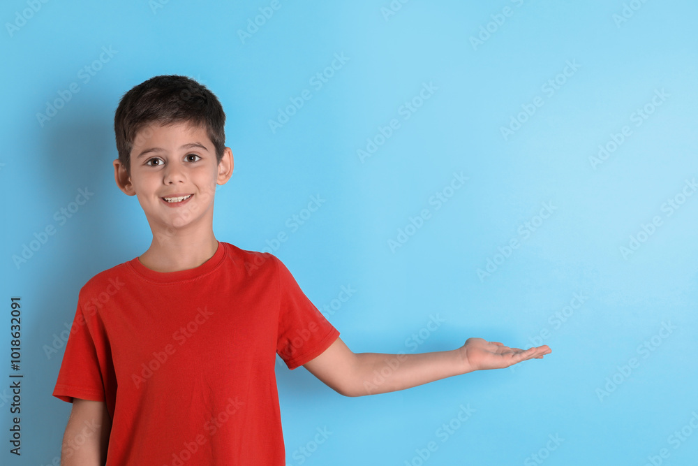 Portrait of cute little boy on light blue background Portrait of cute little boy on light blue background