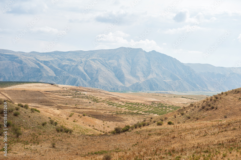 Majestic mountains under a blue sky filled with clouds, showcasing natural beauty and rugged terrain Majestic mountains under a blue sky filled with clouds, showcasing natural beauty and rugged terrain