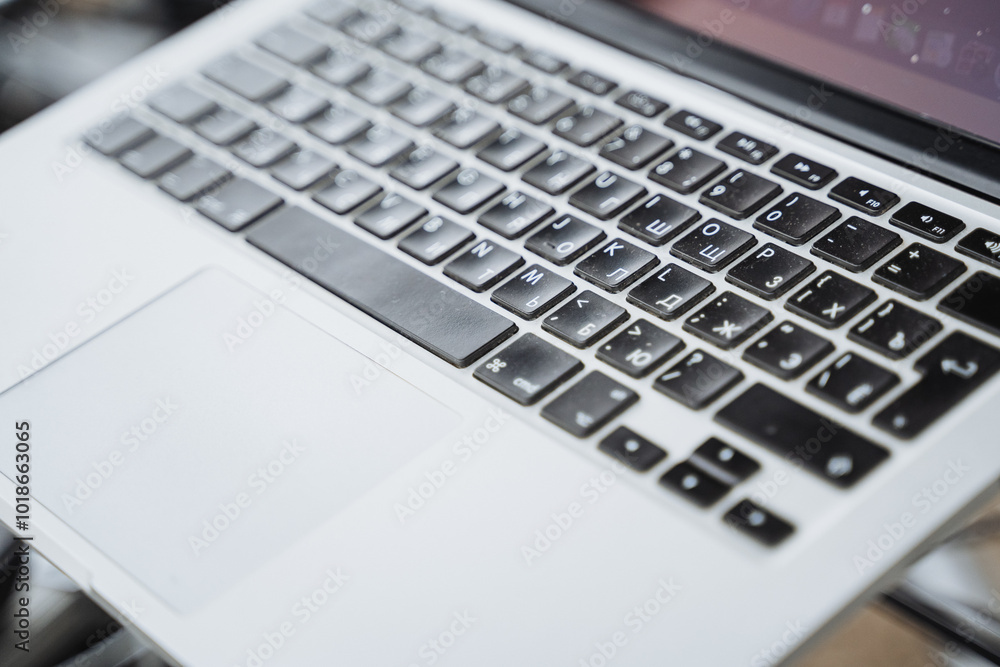 This image presents a closeup of a laptop keyboard on a table, highlighting its keys, layout, and design, offering insight into modern computing technology and its functions This image presents a closeup of a laptop keyboard on a table, highlighting its keys, layout, and design, offering insight into modern computing technology and its functions