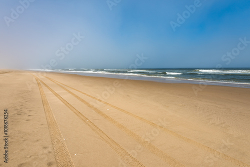 Car tire tracks in the sand of Skeleton Coast, Namibia photo