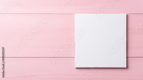 Blank canvas on a pink wooden background, ideal for art or design projects.