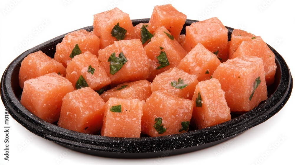 Fresh watermelon cubes served in a black bowl against a white background. Fresh watermelon cubes served in a black bowl against a white background.