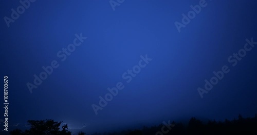 View of Gotemba city and the crescent moon from the foggy Hakone mountains in Japan. 4K,H.264,422,10bit. photo