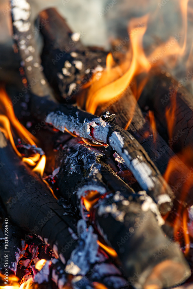 Red hot charcoal and a flame of fire.Close-up of fire, glowing charcoal and hot embers. The texture of flaming burning firewood. Red hot charcoal and a flame of fire.Close-up of fire, glowing charcoal and hot embers. The texture of flaming burning firewood.