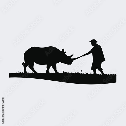 A silhouette of a person herding a rhinoceros in a grassy field 