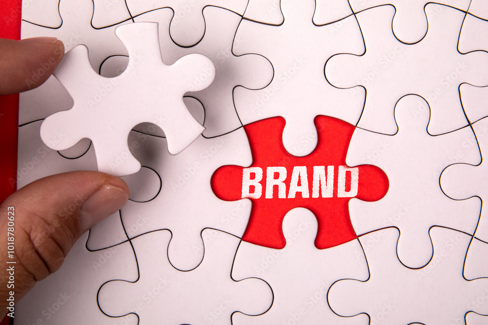 Brand Concept. White puzzle pieces and text on an red background Brand Concept. White puzzle pieces and text on an red background